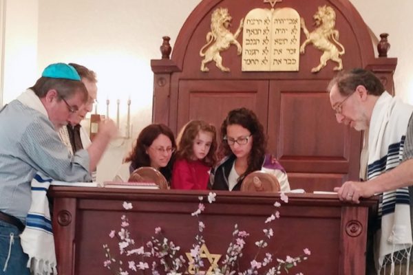 Adults & Children praying at Congregation Shaarei Zedeck in Clinton, MA